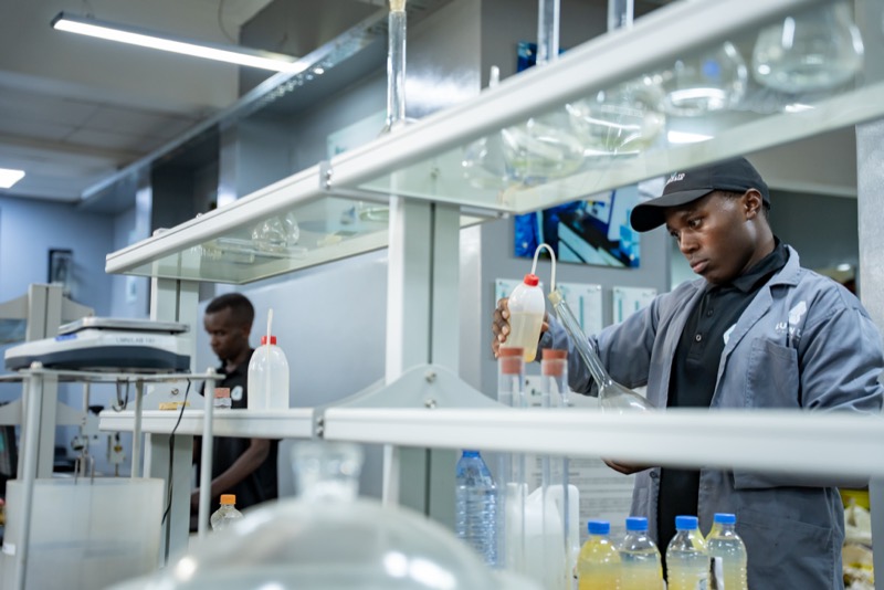 Technician preparing a solution in laboratory glassware