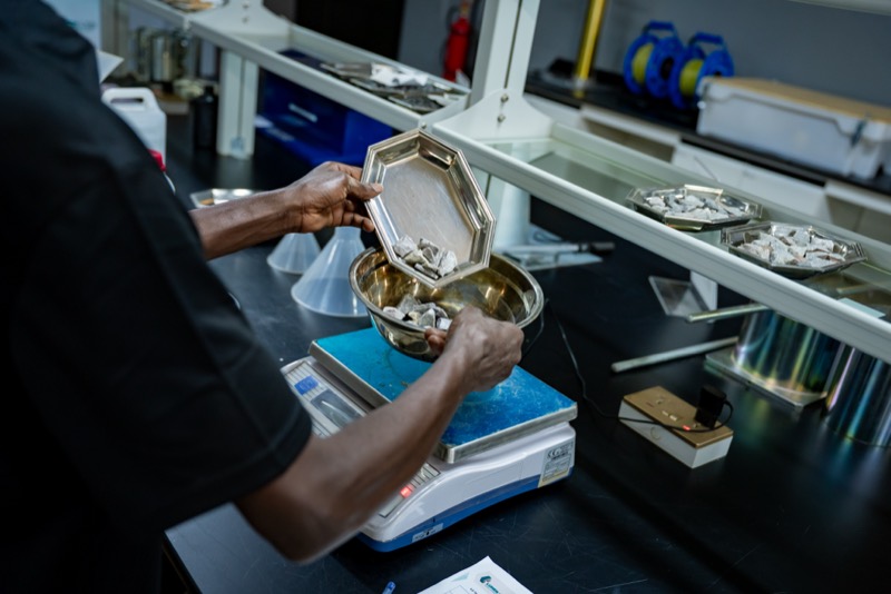 Technician weighing an aggregate sample on a balance